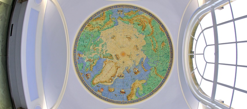 Painted world map, appearing on the ceiling of a building.